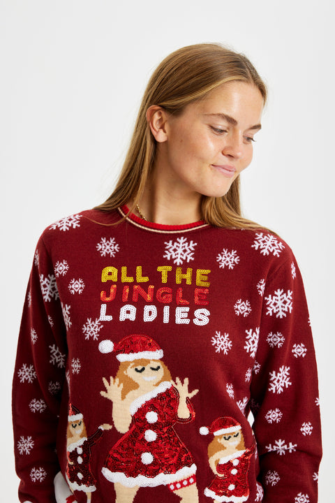 En dame fra torsoen og op, som er iført en julesweater med citatet "All My Jingle Ladies" og dansende kvinder med juletøj.
